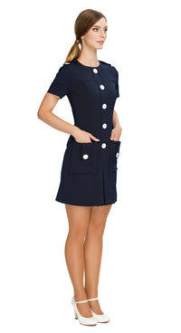 Elevate your wardrobe with our Fitted Sixties Style Dress; perfect for work or play. This dress boasts a uniformed aesthetic, flattering panel craftsmanship, and decorative button torso detailing. With deep skirt pockets, a front pleat, and decorative button-down shoulder tabs, it combines elegance and functionality effortlessly.