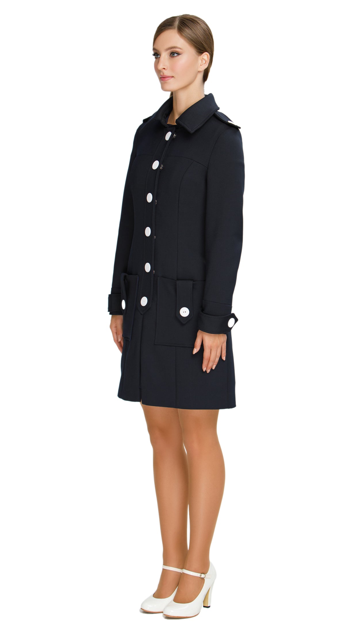 Discover our Fitted Sixties Style Coat, a timeless addition to your outerwear collection. This coat showcases a uniformed aesthetic with impeccable panel craftsmanship and eye-catching decorative button torso closure. Featuring deep front waist-level pockets, a slight flair, and decorative button-down shoulder tabs; it seamlessly combines style and functionality.