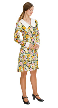 Our Autumn Floral Shift Dress; a versatile and charming addition to your wardrobe. This dress boasts a vibrant floral pattern in tones that evoke the essence of autumn, making it the perfect choice for both work and leisure. The oversized collar and white cuffed long sleeves with white button detailing add a touch of sophistication to the piece.