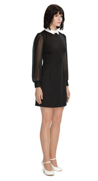 Shop our Autumn 60s style Classic Little Black Dress with flattering sheer sleeves, fitted cuffs, and a contrasting white collar. This chic dress boasts a flattering silhouette, making it the perfect choice for any special occasion this season. Elevate your autumn fashion with timeless elegance.