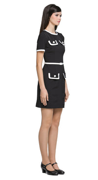 This classic black short-sleeved dress redefines timeless elegance with its unique decorative contrast detailing. Featuring faux matching top and skirt pockets; it offers a modern twist on a wardrobe staple. The neck and sleeve cuffs are accented with a white contrast, enhancing its refined silhouette. A detachable belt in a matching hue adds versatility and structure, complementing the clean lines and flattering fit. Whether worn for a day at the office or an evening out, this dress embodies understated so