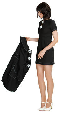 Discover the elegance of our versatile 1960s mod style Little Black Dress, featuring short sleeves and the option for 3/4” sleeves. With a rounded neckline, flattering cutout and exquisite white oversized flower buttons accented by contrasting heavy topstitching, this classic piece is a must-have for any special occasion. Its flattering silhouette and slip-into rear zip closure make it suitable for all body types.