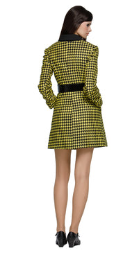Fitted yellow/black houndstooth fair-weather coat featuring an oversized black buckled belt. A playful twist on a classic pattern, this coat brings bold, contrasting details to the forefront. Perfect for pairing with either our Black/Yellow Houndstooth Dress with Front Zipper Pull or our 60s Style Black/Yellow Houndstooth Skirt from this collection for an effortlessly chic and cool Autumn high-fashion vibe. Invisible snap closure. Made from heritage French mill fabric.