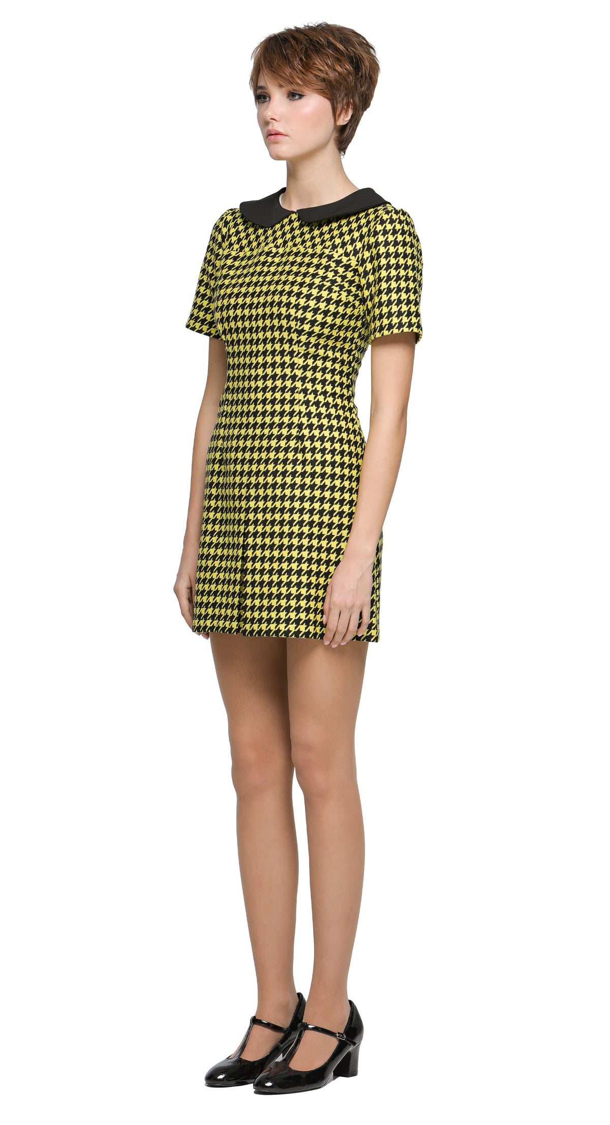Autumn, slightly A-line yellow/black houndstooth, short-sleeve dress with a classic black Peter Pan collar and front pleat. 
Shown here with short sleeves, though alternative sleeve and hem lengths are available. A lively retake on a classic houndstooth look, enhanced by uplifting colors. Made from a French heritage mill fabric.