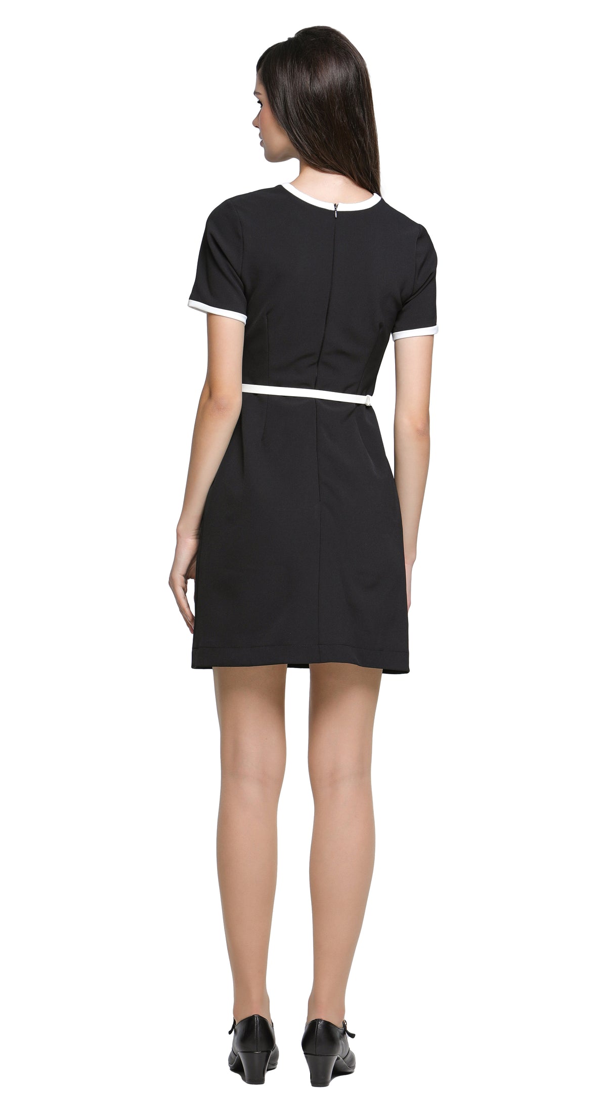 This classic black short-sleeved dress redefines timeless elegance with its unique decorative contrast detailing. Featuring faux matching top and skirt pockets; it offers a modern twist on a wardrobe staple. The neck and sleeve cuffs are accented with a white contrast, enhancing its refined silhouette. A detachable belt in a matching hue adds versatility and structure, complementing the clean lines and flattering fit. Whether worn for a day at the office or an evening out, this dress embodies understated so