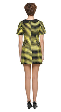 Autumn, slightly A-line yellow/black houndstooth, short-sleeve dress with a classic black Peter Pan collar and front pleat. 
Shown here with short sleeves, though alternative sleeve and hem lengths are available. A lively retake on a classic houndstooth look, enhanced by uplifting colors. Made from a French heritage mill fabric.