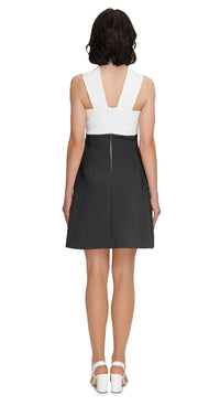Elevate your spring wardrobe with our 1960s Style Pink/White Circle Cutout Dress. Featuring thick neck straps and circular loop detailing. Shop now for effortless spring style!