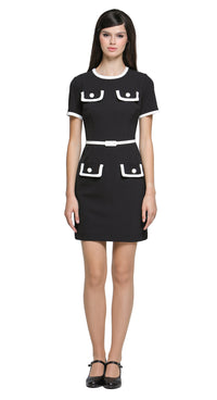This classic black short-sleeved dress redefines timeless elegance with its unique decorative contrast detailing. Featuring faux matching top and skirt pockets; it offers a modern twist on a wardrobe staple. The neck and sleeve cuffs are accented with a white contrast, enhancing its refined silhouette. A detachable belt in a matching hue adds versatility and structure, complementing the clean lines and flattering fit. Whether worn for a day at the office or an evening out, this dress embodies understated so