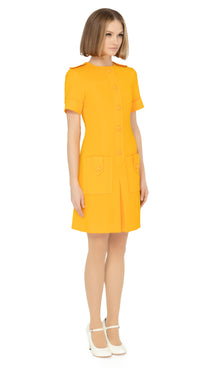 Fitted sixties cut dress with decorative five button placket, button shoulder tabs, short sleeves and functioning button tab essentials pockets with an attractive skirt pleat & immediately striking detailing throughout the bold bright orange Spanish fabric. An entrance maker for all functions, dressed to the nines with heels or casual and cool with kicks or flats.  Please choose bespoke to alternate sleeve or hem length.  Available in various colours. Please contact us for more information.