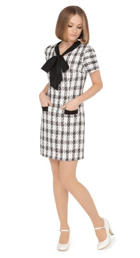 Autumn/winter work-or-play sixties classic cut dress with dramatic black contrasting bow, black contrasting trimmed essentials pockets and short sleeves in a beautiful black and light cream Spanish weave.  Choose bespoke for sleeve and hem length options.  Pairs perfectly with our Retro Style Coat with Detachable Faux Fur Collar and Cuffs to complete the look of this classic set.