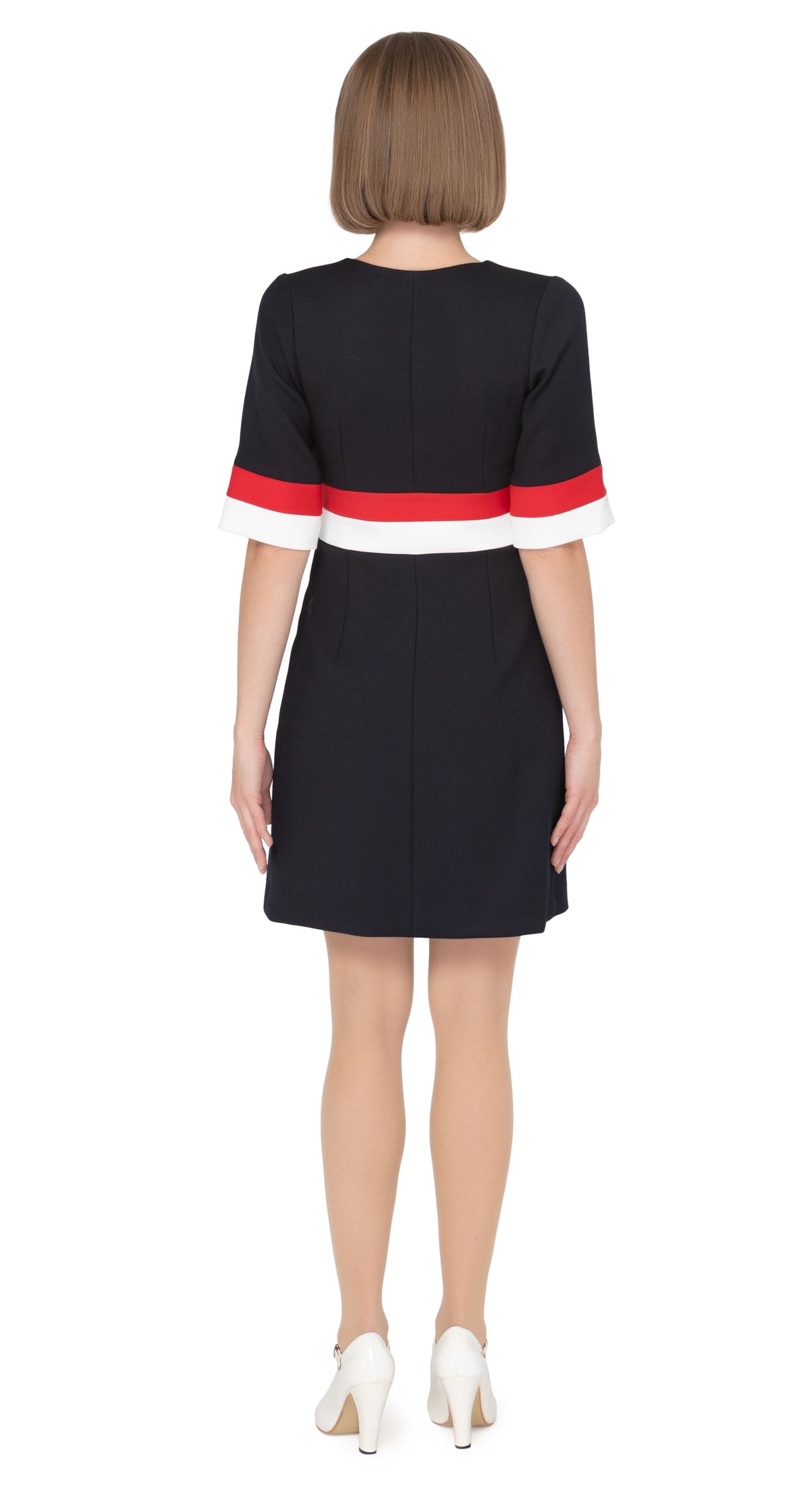 Elegant open neckline tri-colour work-or-play dress with navy blue as the primary colour leading into light cream and red bands on waistline and cuffs with two decorative gold coloured buttons.  Pairs perfectly with our Sixties Style Navy/Red/Light Cream Coat to complete a very wearable and versatile high fashion style for all occasions.