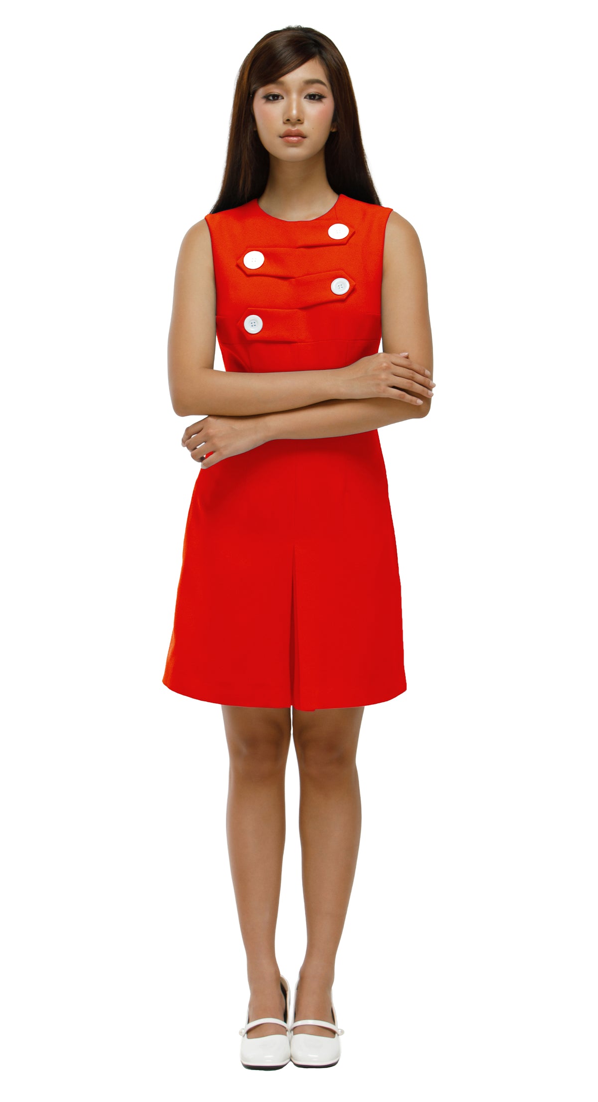 Woman wearing a red dress with white polka dots on a white background