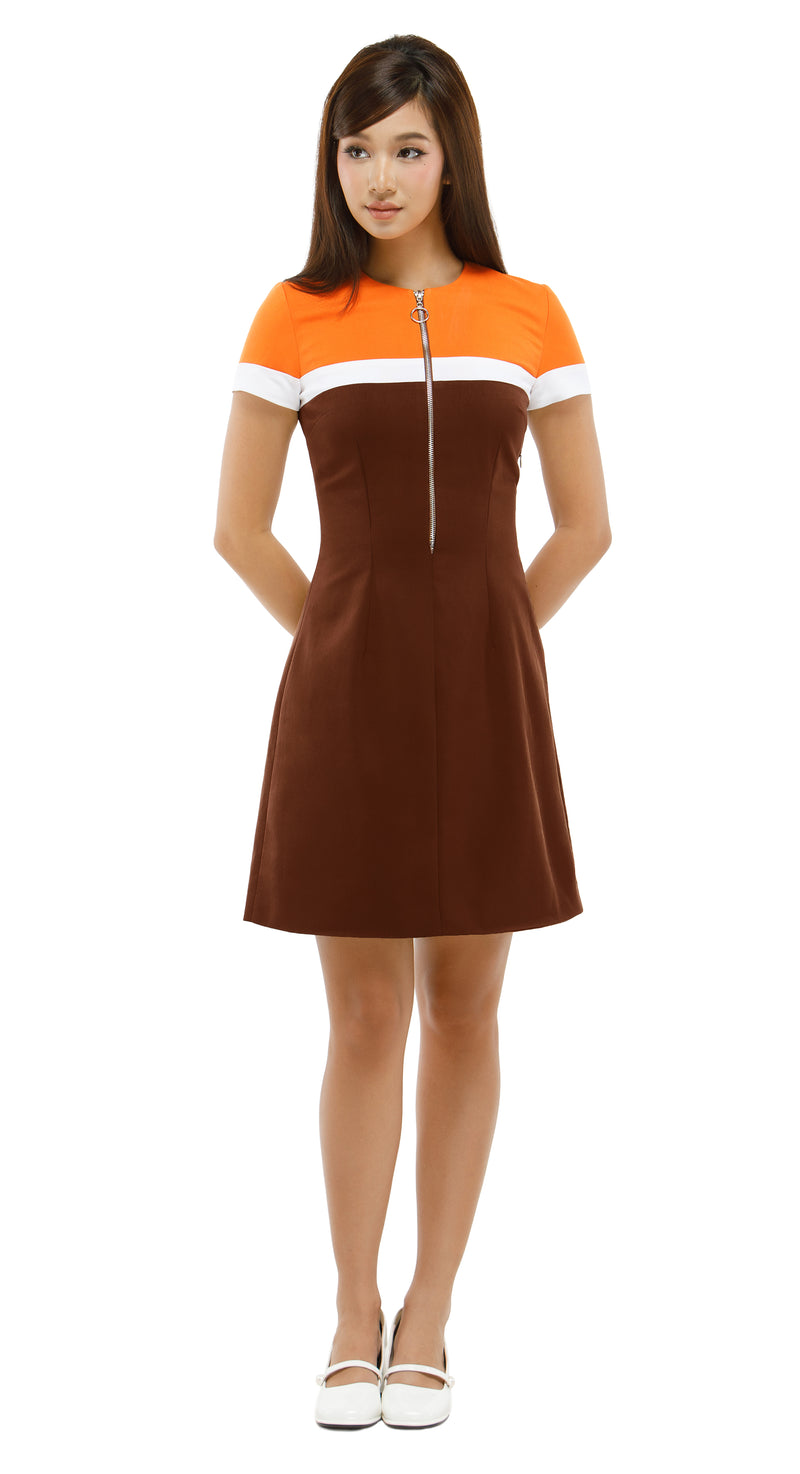 Woman wearing a brown and orange dress on a white background