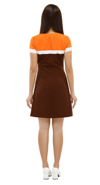 Woman wearing a dress with an orange top and brown skirt on a white background