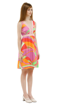 Model wearing a colorful dress with a white background