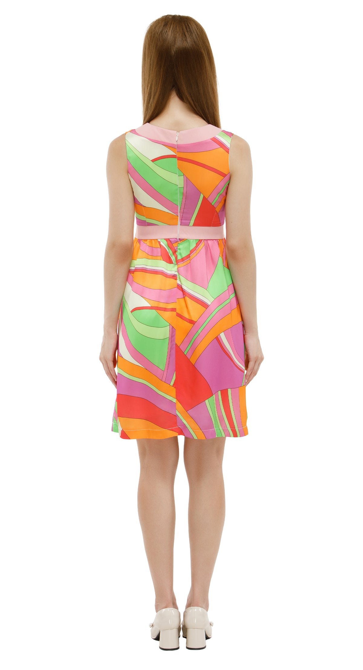 Woman wearing a colorful dress with abstract pattern on a white background
