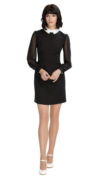 Shop our Autumn 60s style Classic Little Black Dress with flattering sheer sleeves, fitted cuffs, and a contrasting white collar. This chic dress boasts a flattering silhouette, making it the perfect choice for any special occasion this season. Elevate your autumn fashion with timeless elegance.