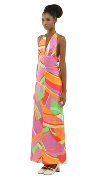 Woman wearing a colorful patterned dress on a white background
