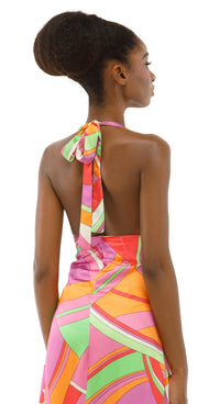 Woman wearing a colorful patterned dress on a white background