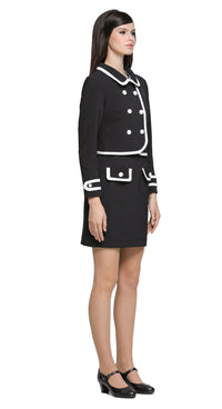 Cropped autumn classic-look jacket with contrasting detailing across the hem and collar, six-button detail, and contrasting outlined cuff epaulettes. A versatile piece to pair with a plain skirt or pants, but also pairs seamlessly with our Classic Black Dress with White Trim from this collection, offering a chic, wearable option for both leisure and professional looks.