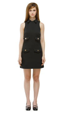 Confidently retro, this&nbsp;Little Black Dress&nbsp;channels classic sixties style with a fitted silhouette that flatters every figure. Crafted with a sleek, structured cut, it balances elegance with subtle practicality for a polished, effortless look.

The dress features&nbsp;two discreet waist-level functional pockets&nbsp;and&nbsp;two midriff decorative flap faux pockets&nbsp;for refined detailing. A&nbsp;sleeveless design&nbsp;with a&nbsp;short-cut shirt collar&nbsp;and gently&nbsp;raised neckline&nbsp