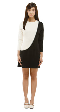 Woman wearing a black and white dress on a white background