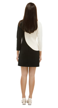 Woman wearing a black and white dress on a white background