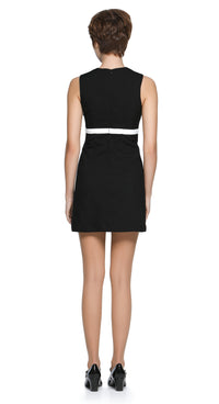 Autumn, mod style little black dress with a slight A-line, rounded neckline, detailed with a carefully sewn floral cut-out on the torso, accented by a contrasting high waist-level bow. Shown here as sleeveless, but available with alternative sleeve and hem lengths to suit preference. A simple, fun, and striking dress that's easy to reach for and pairs well with both heels and pumps. 