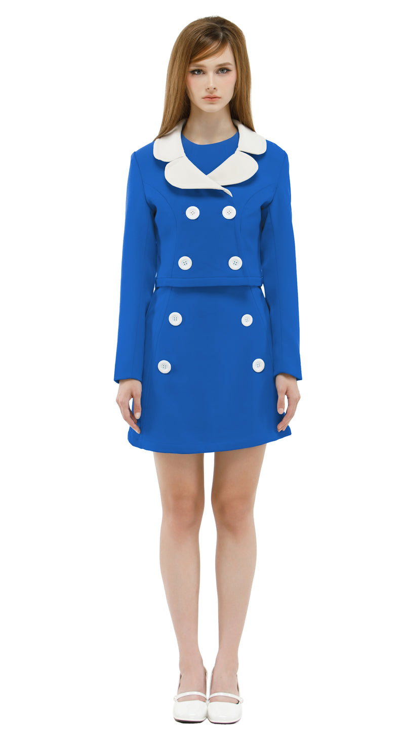 Woman wearing a blue/white mod 1960s dress and jacket on a white background