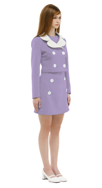 Woman wearing a lavender/white mod 1960s dress and jacket on a white background