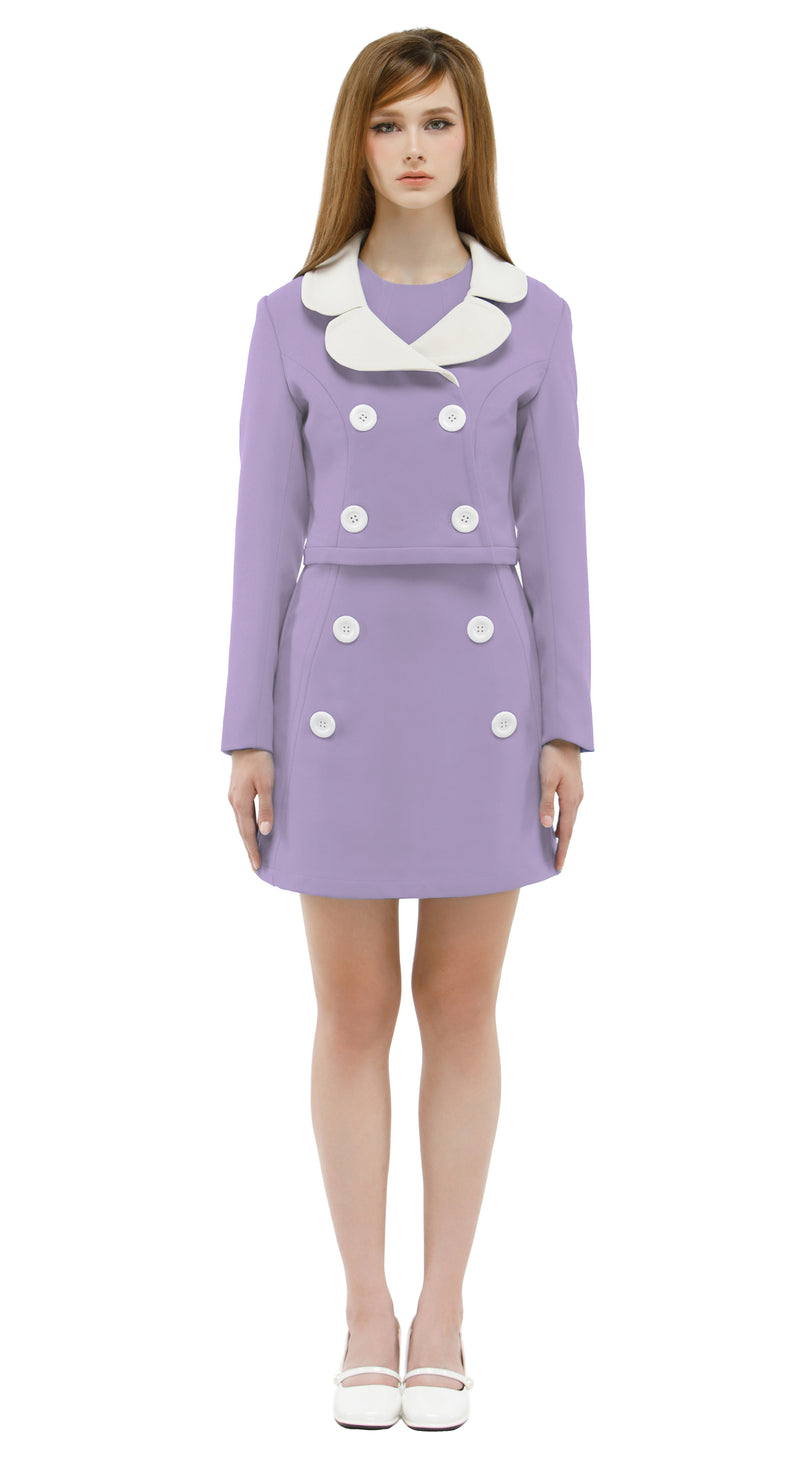 Woman wearing a lavender/white mod 1960s dress and jacket on a white background
