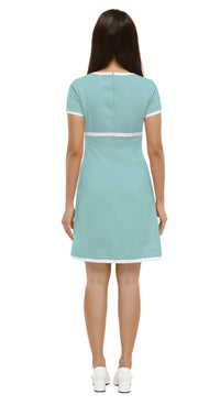 Woman wearing a  mint green, Mod 1960s style dress with white accents, 2 diamond cutouts and 2 small bows on a white background