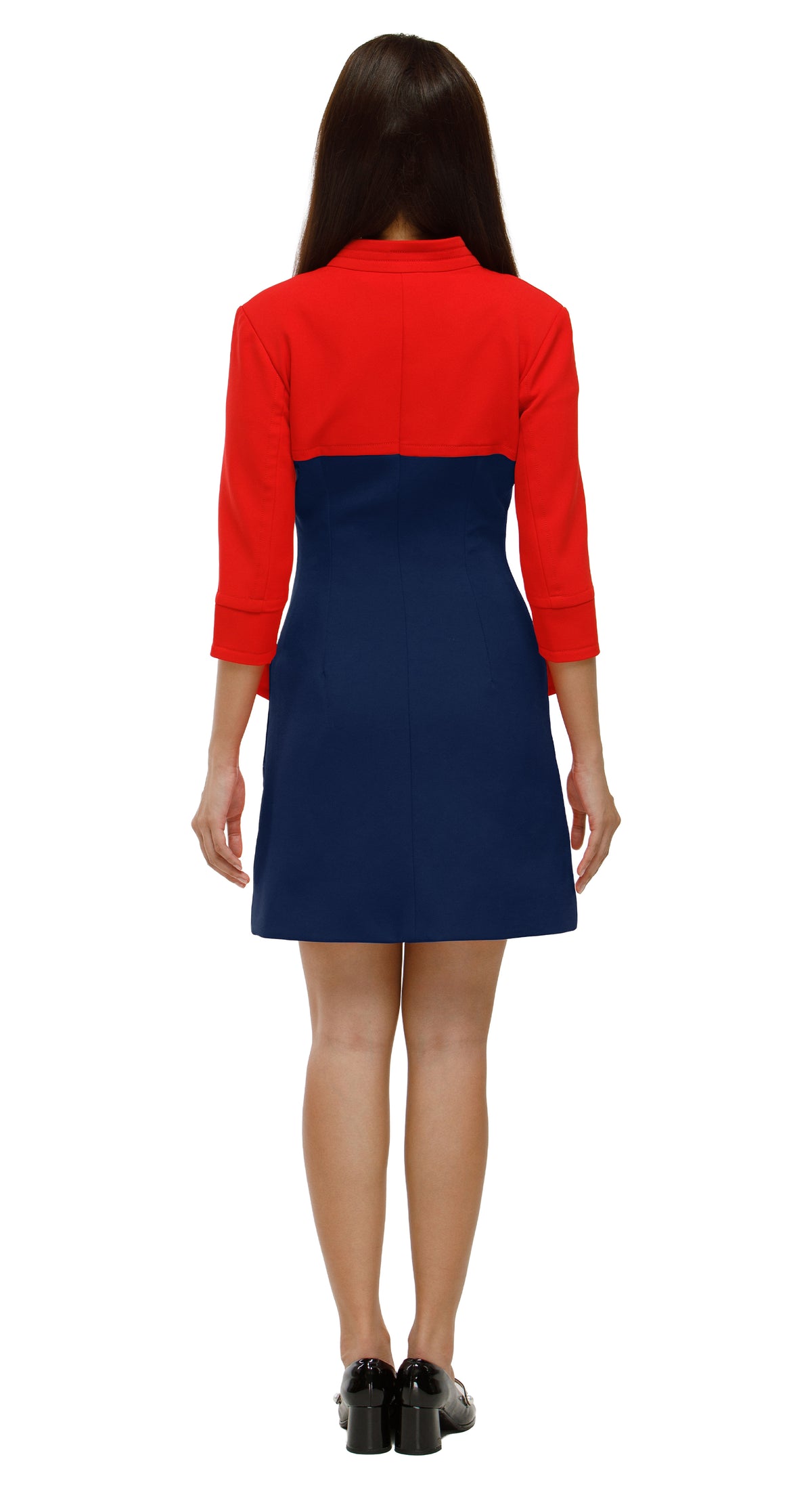 Woman wearing a red and blue dress on a white background