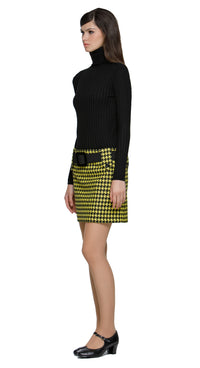 Autumn, yellow/black houndstooth mini skirt featuring large button-down belt loops and an oversized black buckled belt. A playful twist on a classic pattern, this skirt brings bold, contrasting details to the forefront. Perfect for pairing with a simple top or layered for a more dynamic look. Available in alternative lengths for added versatility. Made from heritage French mill fabric.

The model pictured is 180 cm tall and wears a size XS.
Fabric Content: 39% PC / 30% PL / 16% WO / 15% PA.
Fabric provides 