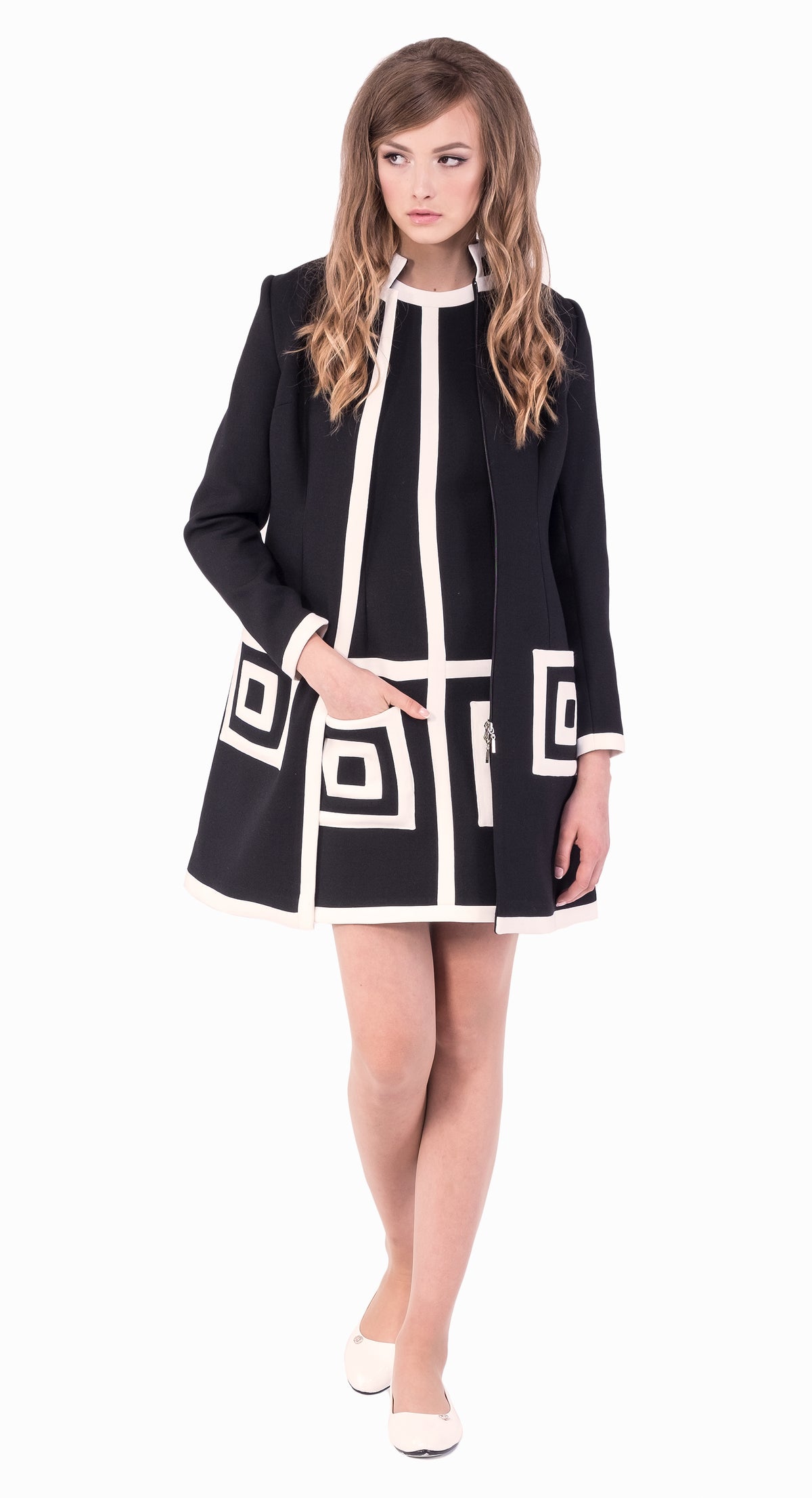 Elevate your autumn-winter style with our medium-weight Italian fair-weather coat. This black/light cream, sixties-inspired full-length coat seamlessly combines classic design with modern comfort; it’s perfect for various occasions. The standout feature is the very intricate geometric pocket detailing, adding a touch of drama to this elegant piece. Stay warm, stylish, and conversation-ready this season.