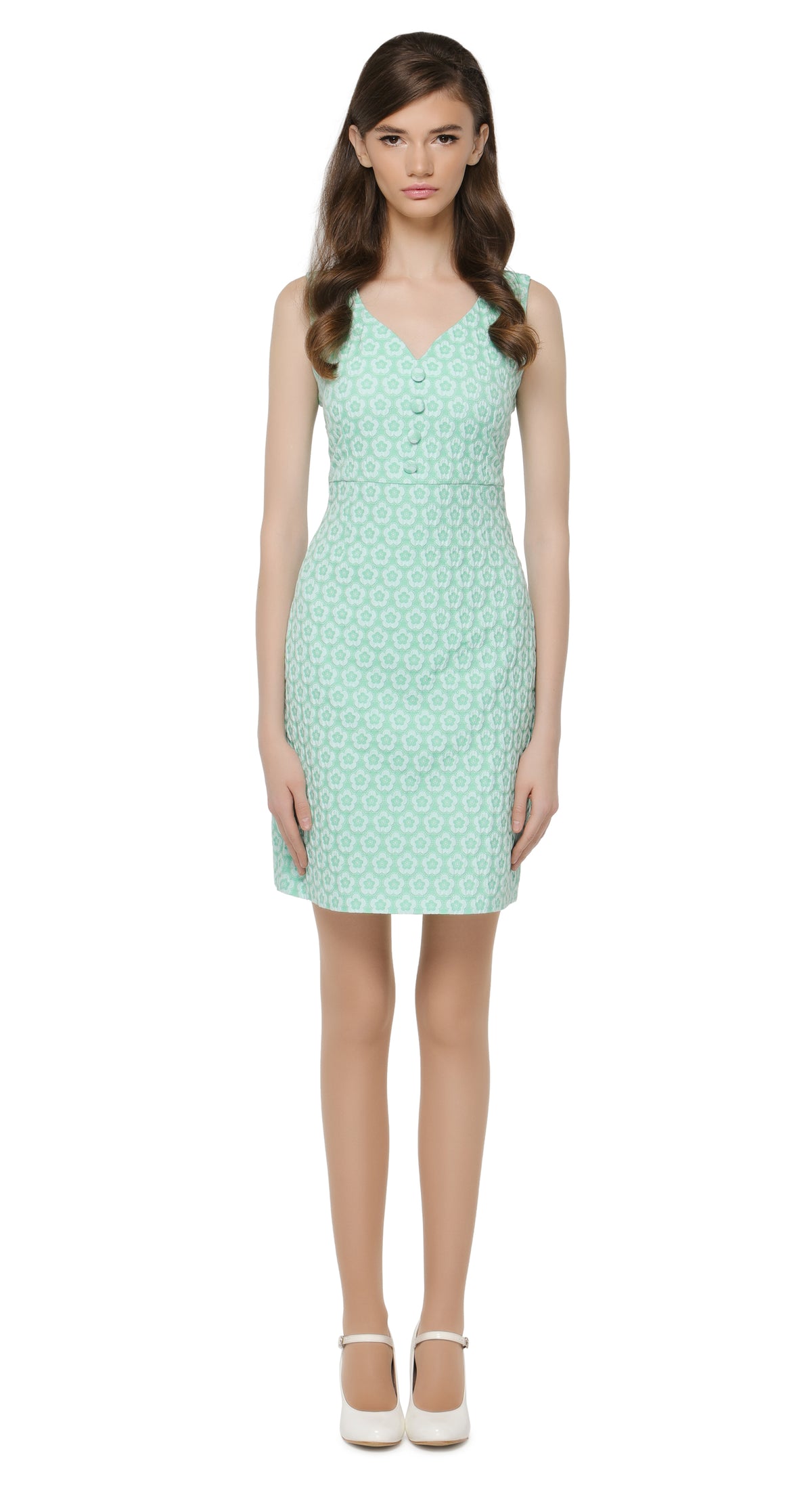 Mint green spring outing dress with matching covered button decoration below a curved v-neckline.  A stunning French jacquard fabric lends itself perfectly to an immediately feminine silhouette and a classic, easy to wear entrance maker.  Choose bespoke for custom measurements, to add short or capped sleeves and/or amend hem length.