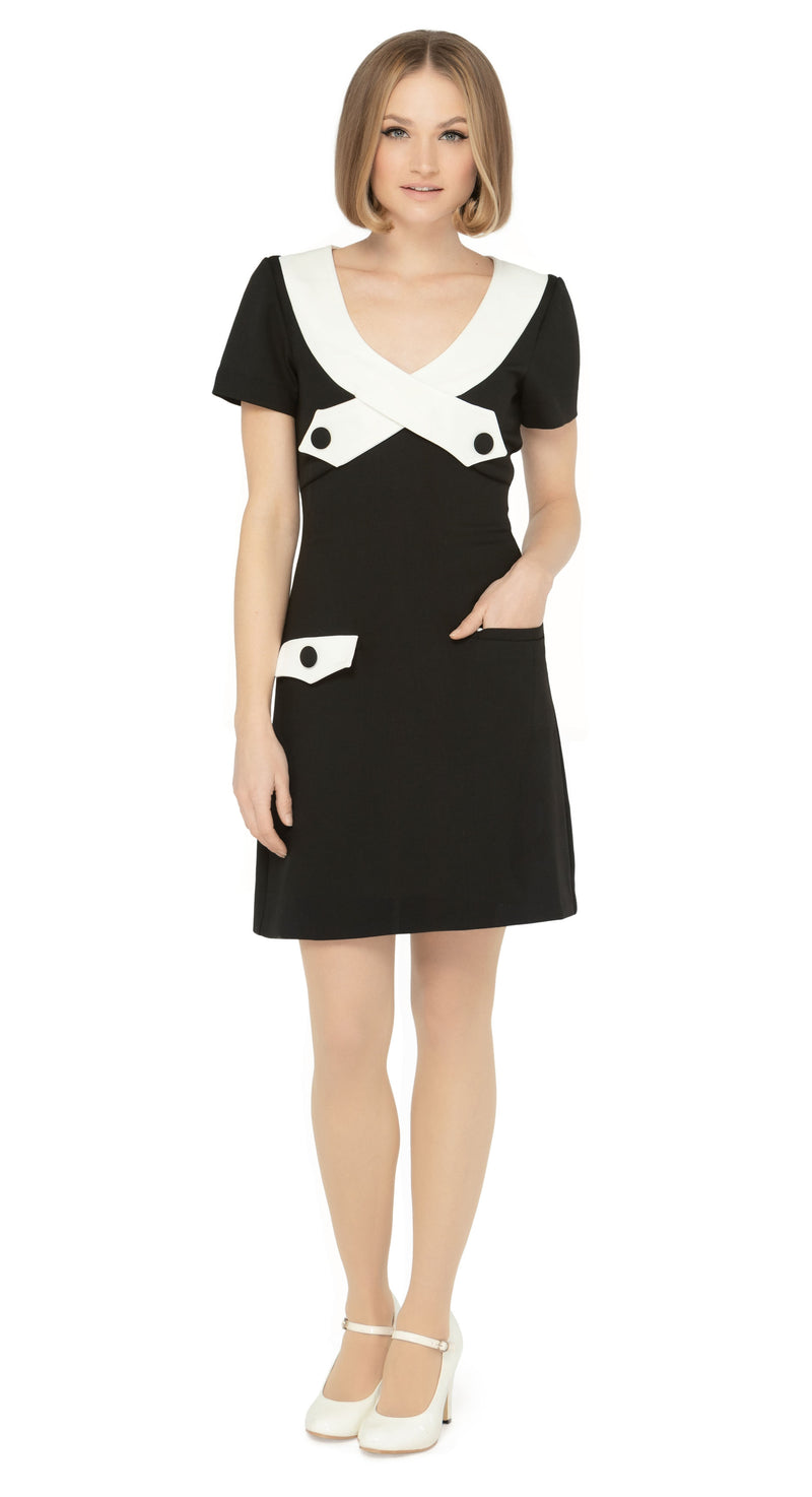 Beyond a fitted Little Black Dress (a must-have for any wardrobe), our contrasting white dramatic neckline adds a touch of sophistication, while the imaginative creative detailing through decorative button placement and button-down essentials pockets makes for a very wearable and functional look. With a slightly A-lined skirt and short sleeves, this dress proves flattering on all figures.