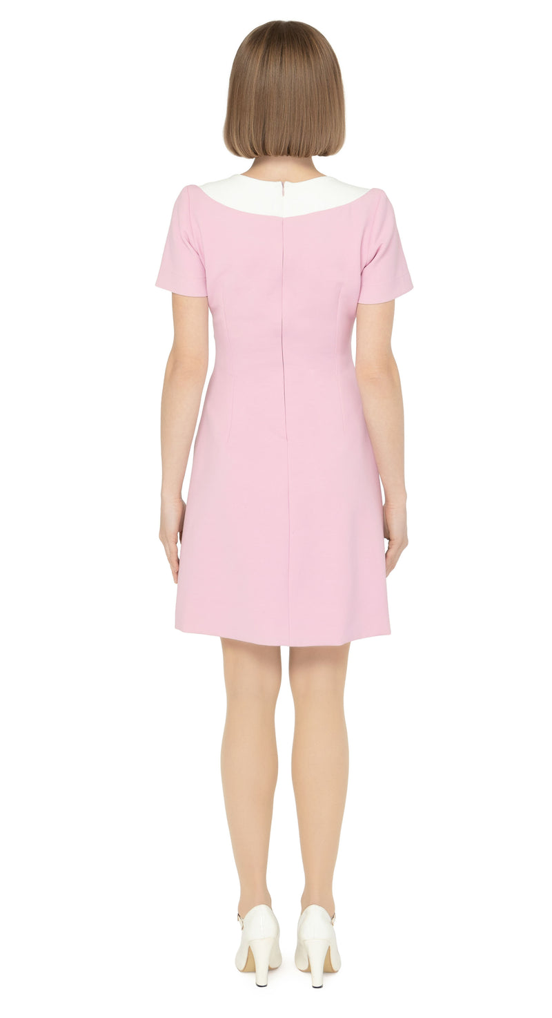 The contrasting dramatic white  neckline adds a touch of sophistication, while the imaginative creative detailing through decorative button placement and button-down essentials pockets makes for a very wearable and functional look. With a slight A-line skirt and short sleeves, this dress proves flattering on all figures.
