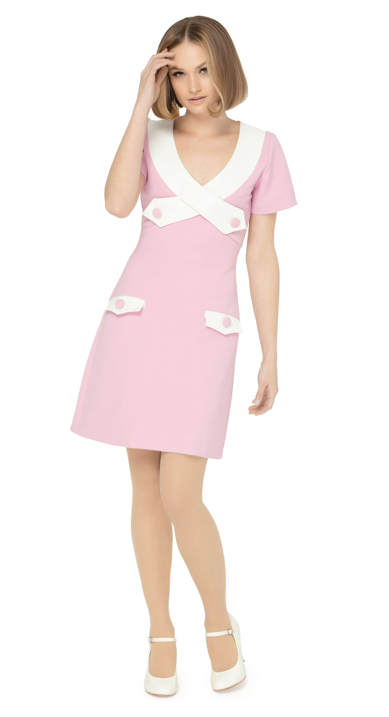 The contrasting dramatic white  neckline adds a touch of sophistication, while the imaginative creative detailing through decorative button placement and button-down essentials pockets makes for a very wearable and functional look. With a slight A-line skirt and short sleeves, this dress proves flattering on all figures.
