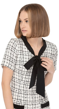 Autumn/winter work-or-play sixties classic cut dress with dramatic black contrasting bow, black contrasting trimmed essentials pockets and short sleeves in a beautiful black and light cream Spanish weave.  Choose bespoke for sleeve and hem length options.  Pairs perfectly with our Retro Style Coat with Detachable Faux Fur Collar and Cuffs to complete the look of this classic set.