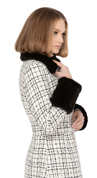 Light cream and black Spanish weave fair-weather autumn coat. Classic sixties fitted body with a double breasted four button closure and fabric covered belt. Unique indistinguishable from the real thing, faux fur detachable cuffs and collar.  Pairs as intended with our Sixties Style Dress with Black Bow and our Retro Dress with Belt to create a timeless set.