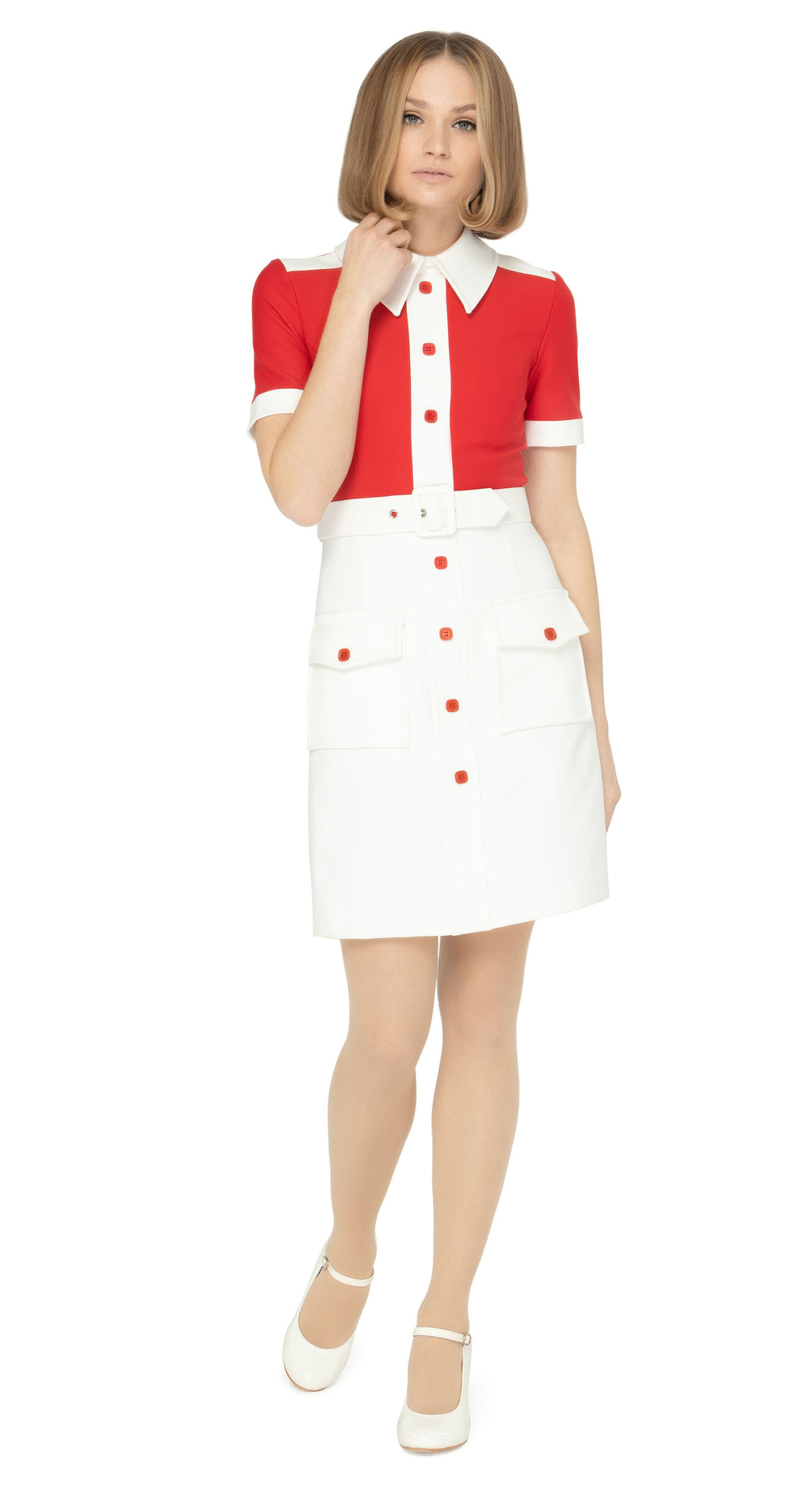 Spring, sixties cut dress with a fitted silhouette, featuring a striking contrast of red and white. It has a white skirt, collar, cuffs, and shoulder detailing on a bright red torso, with matching red petite buttons and essentials skirt pockets. This dress includes a detachable matching belt.