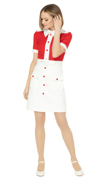 Spring, sixties cut dress with a fitted silhouette, featuring a striking contrast of red and white. It has a white skirt, collar, cuffs, and shoulder detailing on a bright red torso, with matching red petite buttons and essentials skirt pockets. This dress includes a detachable matching belt.