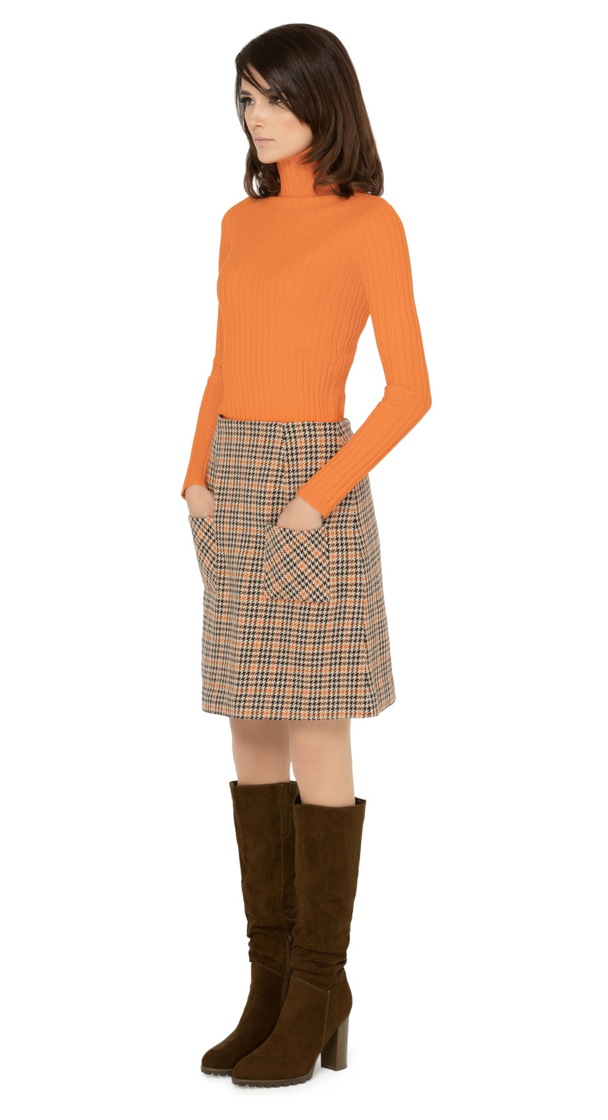 Limited edition, classic fitted, medium weight Italian dogtooth, waist hugging skirt. Warm tones in the weave encourage versatility when dressing up with heels or down with flats or kicks. Worn here with a turtleneck which is sold separately. Please inquire to shop the look.