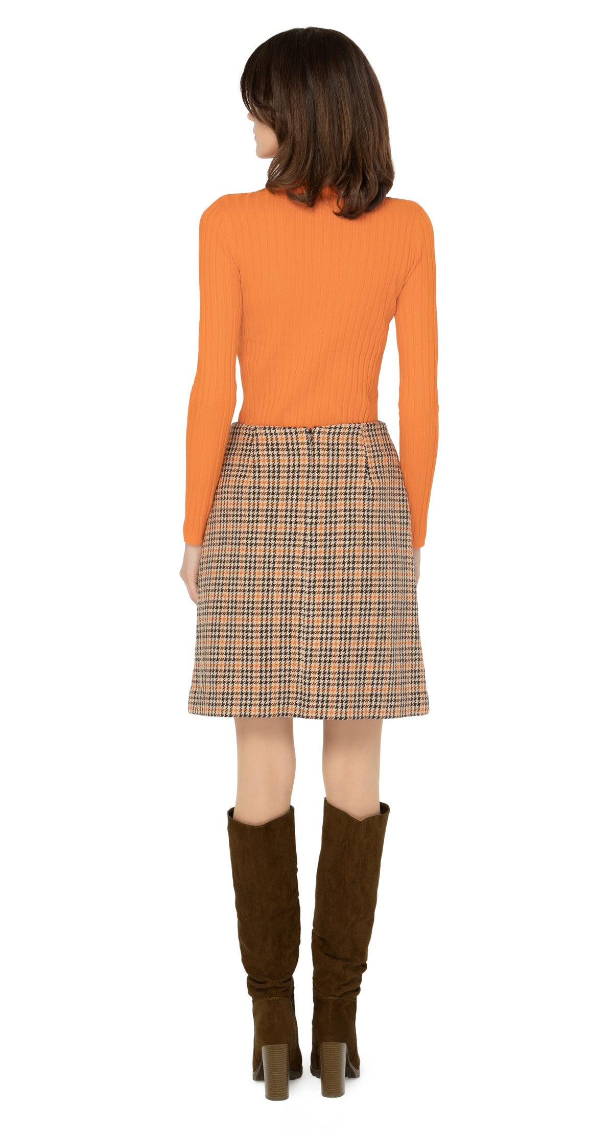 Limited edition, classic fitted, medium weight Italian dogtooth, waist hugging skirt. Warm tones in the weave encourage versatility when dressing up with heels or down with flats or kicks. Worn here with a turtleneck which is sold separately. Please inquire to shop the look.