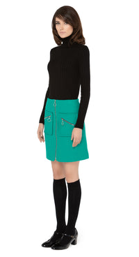 Marmalade zip up skirt in a stunning emerald green Italian wool blend, with functioning retro loop zip essentials pockets, and front retro loop zipper closure.  Shown here, worn with a classic black ribbed turtleneck and knee highs which are sold separately. Please inquire to shop the full look. Also available in classic black.  Pairs perfectly as intended with our 1960s Style Coat with Detachable Faux Fur.