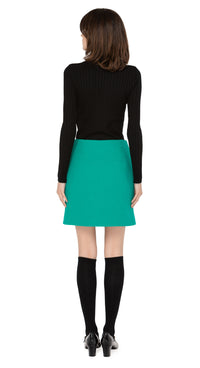 Marmalade zip up skirt in a stunning emerald green Italian wool blend, with functioning retro loop zip essentials pockets, and front retro loop zipper closure.  Shown here, worn with a classic black ribbed turtleneck and knee highs which are sold separately. Please inquire to shop the full look. Also available in classic black.  Pairs perfectly as intended with our 1960s Style Coat with Detachable Faux Fur.