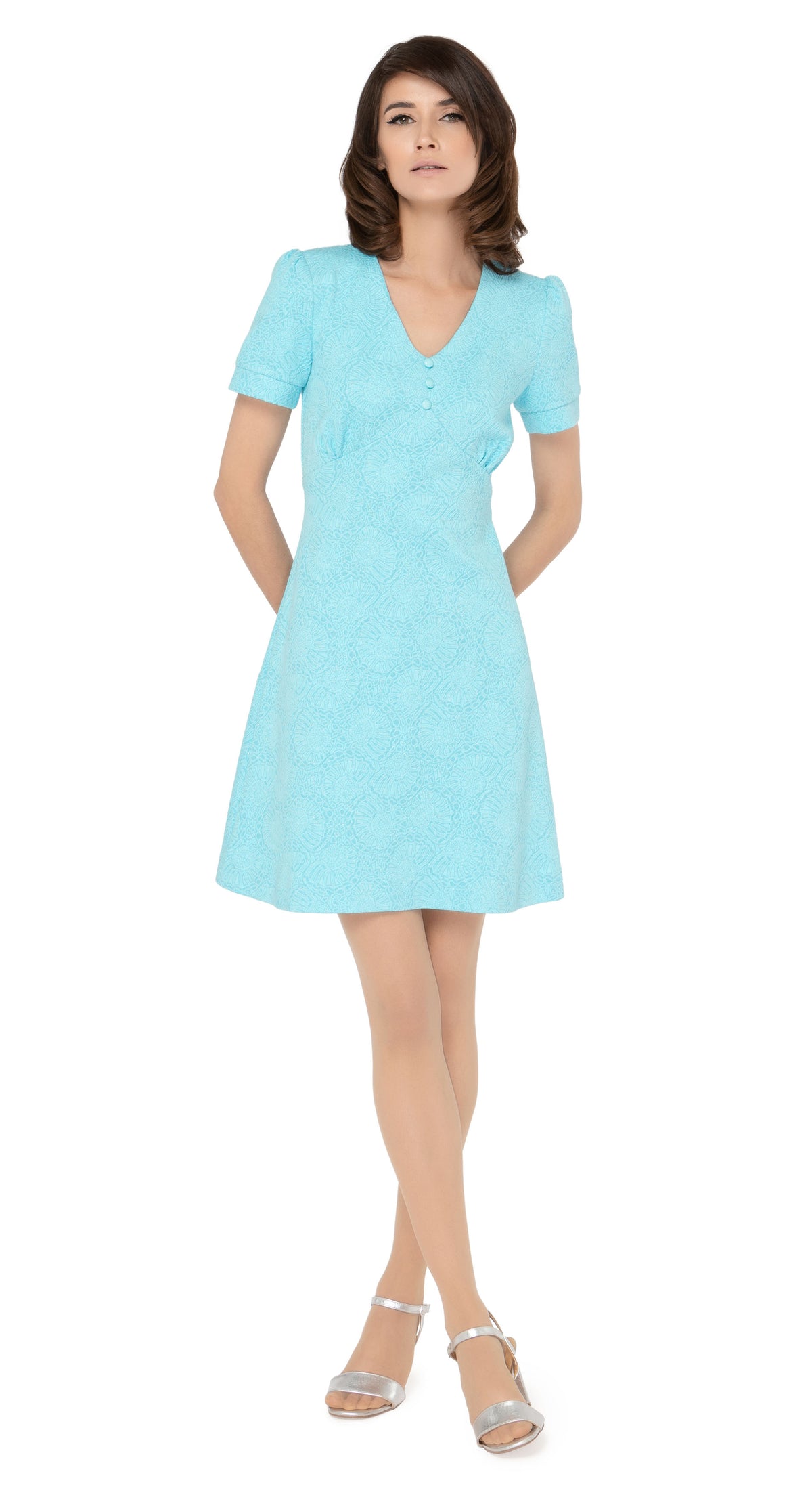 Stunning seventies style, Italian turquoise jersey, slightly flared dress with fitted torso and discreet hints of silver threading throughout the textured fabric. V-neckline, with three button detailing and slightly puffed short sleeves.  Choose bespoke for mid-length or long sleeves or an alternate hem length.