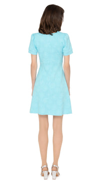 Stunning seventies style, Italian turquoise jersey, slightly flared dress with fitted torso and discreet hints of silver threading throughout the textured fabric. V-neckline, with three button detailing and slightly puffed short sleeves.  Choose bespoke for mid-length or long sleeves or an alternate hem length.